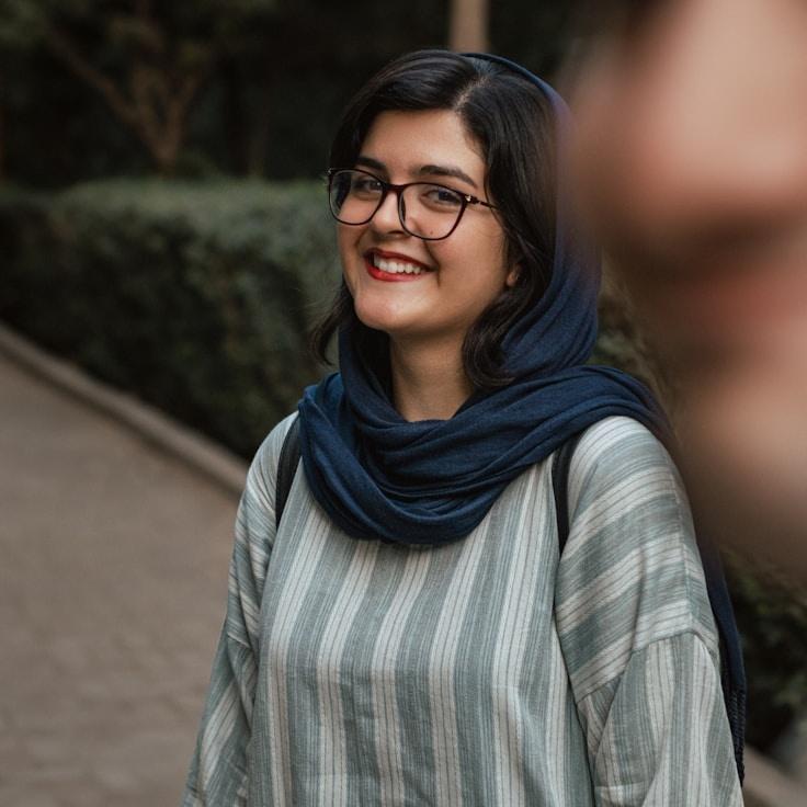 Mia Chen, Lead Design Curator at QuartzGrovePond, reviewing corporate floral arrangements